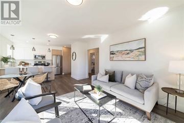 Toronto (Lawrence Park South) apartment for rent - A well-lit living room with a white sofa and a painting on the wall.