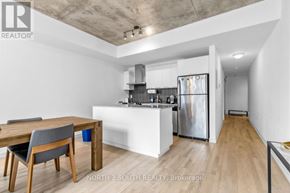 Toronto (Waterfront Communities) condo for rent - A modern kitchen with a dining table and chairs.