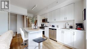 Toronto (O'connor-Parkview) townhouse for rent - A white kitchen with a bar stool in front of it.