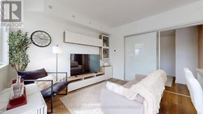 Toronto (O'connor-Parkview) townhouse for rent - A modern living room with a white couch and a flat screen TV.