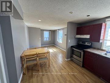 Brampton (Downtown Brampton) apartment for rent - A kitchen with a table and chairs in the middle of the room.