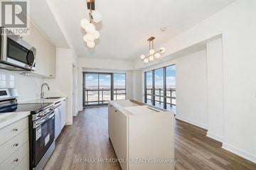Clarington (Bowmanville) condo for rent - A modern kitchen with a stove top oven and microwave.