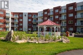 Smiths Falls condo for rent - A gazebo sits in front of apartment buildings.