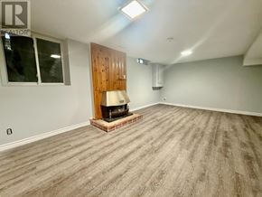 Ajax (South East) apartment for rent - A room with a wood panelled wall and a wood floor.