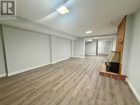 Ajax (South East) apartment for rent - A spacious room with a wooden floor and a large mirror on the wall.