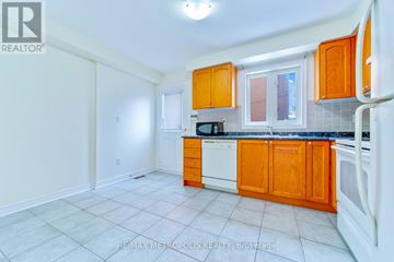 Toronto (O'connor-Parkview) townhouse for rent - A kitchen with orange cabinets and white appliances.
