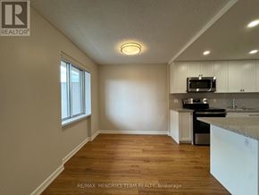 St. Catharines (Lakeport) condo for rent - A kitchen area with a microwave, oven, and sink.
