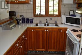 Blue Mountains apartment for rent - A kitchen with wooden cabinets and a white countertop.