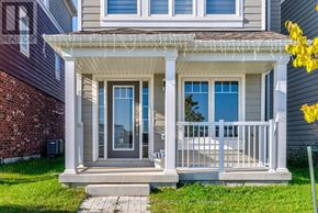 Wasaga Beach apartment for rent - A house with a front porch and a white railing.