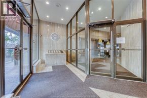 Windsor condo for rent - The lobby of a building with a glass door entrance.