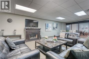 Windsor condo for rent - A living room with a grey leather couch and a coffee table.