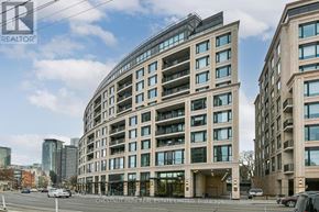 Toronto (Annex) condo for rent - A modern building with a curved facade is the main focus of the image.