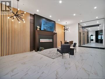 Moncton apartment for rent - A modern living room with a fireplace and a painting on the wall.