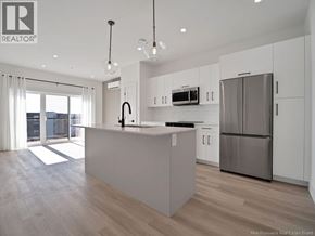 Moncton apartment for rent - A modern kitchen with a large island and stainless steel appliances.