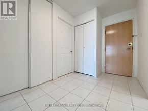 Toronto (Milliken) condo for rent - A room with a white door, a white door, and a brown door.