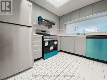 Toronto (Milliken) condo for rent - A kitchen with a white tile floor and a stainless steel refrigerator.