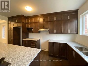 Kitchener apartment for rent - A kitchen with brown cabinets and a white countertop.