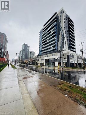 Waterloo condo for rent - A city street with a tall building on the right.