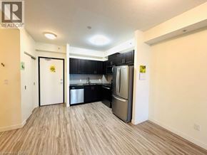 Waterloo condo for rent - A kitchen with black cabinets and stainless steel appliances is shown.