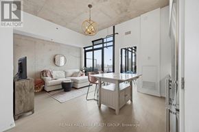 Ottawa condo for rent - A modern living room with a white couch, a wooden coffee table, and a large window.