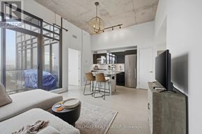 Ottawa condo for rent - A modern living room with a dining area and a kitchen in the background.