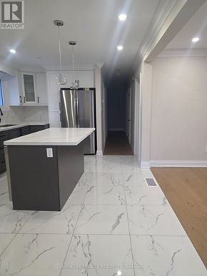 Oshawa (Donevan) apartment for rent - A kitchen with a marble floor and a refrigerator.