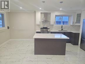 Oshawa (Donevan) apartment for rent - A kitchen with a white countertop and a refrigerator.