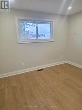 Oshawa (Donevan) apartment for rent - A room with a window and wooden flooring.