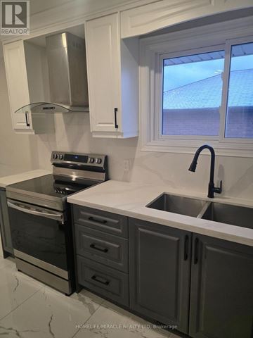 Oshawa (Donevan) apartment for rent - A modern kitchen with a stainless steel oven and sink.