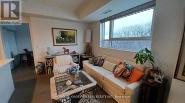 Toronto (Birchcliffe-Cliffside) condo for rent - A living room with a couch, a coffee table, and a painting on the wall.