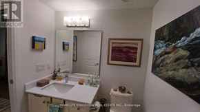 Toronto (Birchcliffe-Cliffside) condo for rent - A bathroom with a sink, toilet and a painting on the wall.