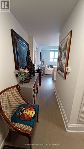 Toronto (Birchcliffe-Cliffside) condo for rent - A hallway with a chair and pictures on the wall.