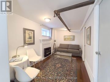 Toronto (Greenwood-Coxwell) apartment for rent - A living room with a fireplace and a rug on the floor.