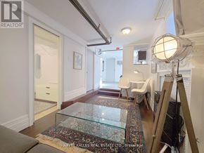 Toronto (Greenwood-Coxwell) apartment for rent - A room with a glass table and a rug in front of it.