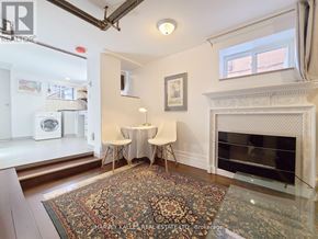 Toronto (Greenwood-Coxwell) apartment for rent - A room with a fireplace and a rug on the floor.