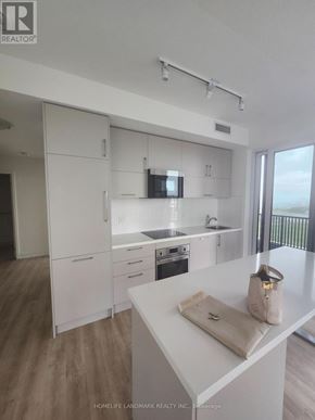 Markham (Unionville) condo for rent - A kitchen with white cabinets and a white counter top.