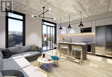 Brantford condo for rent - A modern kitchen with a bar stool and a table with a phone on it.
