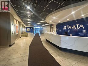Burlington condo for rent - A hallway with a STRATA sign on the wall.