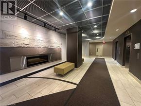 Burlington condo for rent - A hallway with a stone wall and a fireplace.