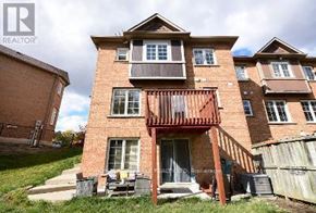 Mississauga (Central Erin Mills) duplex for rent - A two-story brick house with a balcony on the second floor.