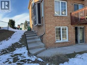 Mississauga apartment for rent - A brick house with a realtor sign in the corner.