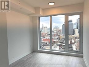 Toronto (Waterfront Communities) condo for rent - A realtor's image of an empty room with a view of the city.