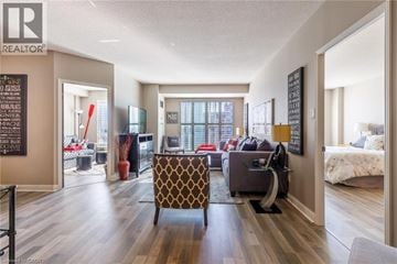 Burlington condo for rent - A living room with a brown patterned chair in the center.