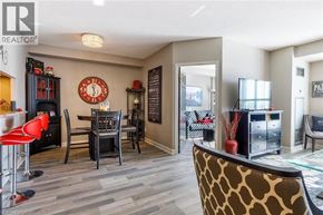 Burlington condo for rent - A living room with a dining table and chairs.