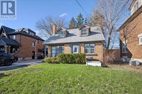 Kitchener multi-family for rent - A house with a brick facade and a large front yard.