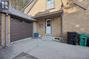Kitchener multi-family for rent - A house with a Real Broker Ontario Ltd. sign in the foreground.