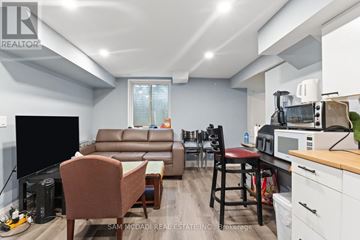 Mississauga (East Credit) apartment for rent - A living room with a brown leather couch and a wooden coffee table.