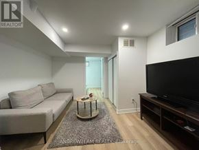 Richmond Hill (Crosby) apartment for rent - A living room with a grey couch, a coffee table, and a flat screen TV.