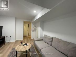 Richmond Hill (Crosby) apartment for rent - A living room with a grey couch, a wooden coffee table, and a flat screen TV.