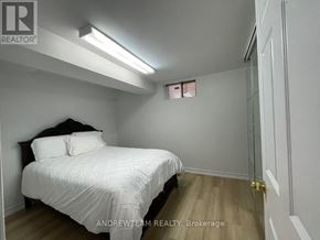 Richmond Hill (Crosby) apartment for rent - A bedroom with a bed, wooden floors, and a window with blinds.